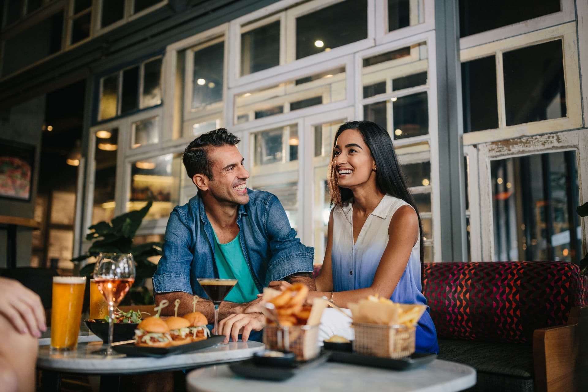 couple-grinning-eating-dinner