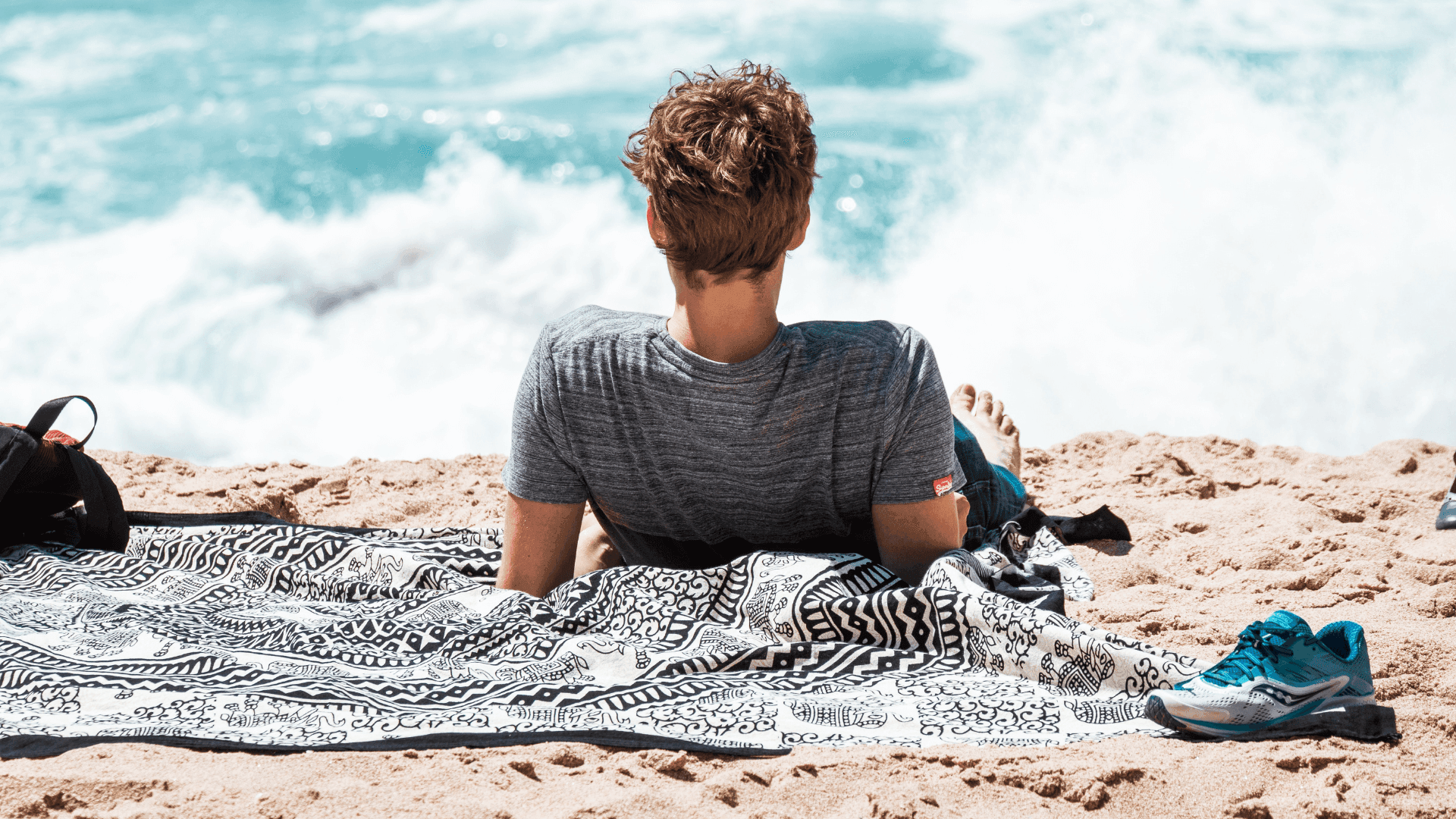 man-sunbaking-on gold-coast-beach