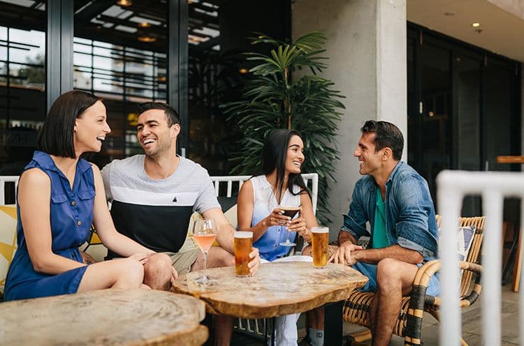 A Group Of People Sitting At A Table