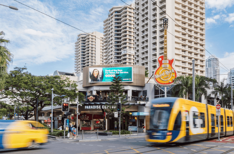 A Double Decker Bus Driving Down A City Street